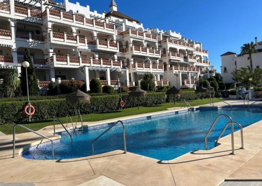 Stylish 2-bed apartment with pool and garden.